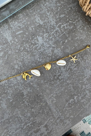 GOLD DOLPHIN BRACELET WITH CREAM AND GOLD SEA CHARMS